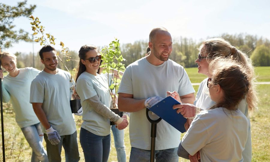 group-of-volunteers-with-tree-seedlings-in-park.jpg